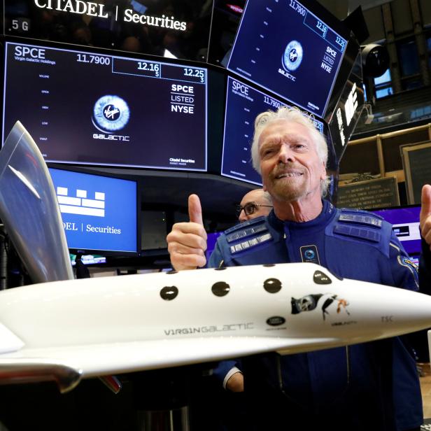 FILE PHOTO: Sir Richard Branson poses on floor of New York Stock Exchange (NYSE) ahead of Virgin Galactic (SPCE) trading in New York