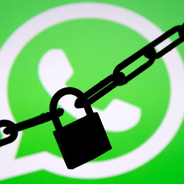 FILE PHOTO: A photo illustration shows a chain and a padlock in front of a displayed Whatsapp logo