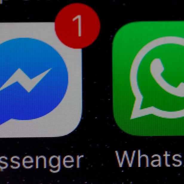 FILE PHOTO: WhatsApp and Facebook messenger icons are seen on an iPhone in Manchester , Britain.