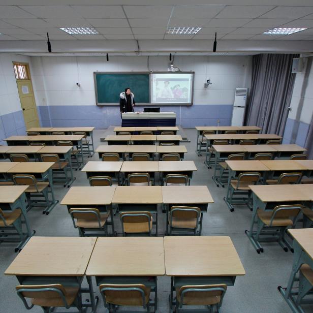 Teacher takes part in a recording of her lessons inside a classroom of a middle school, as students' return to school has been delayed due to the novel coronavirus outbreak, in Shaoyang