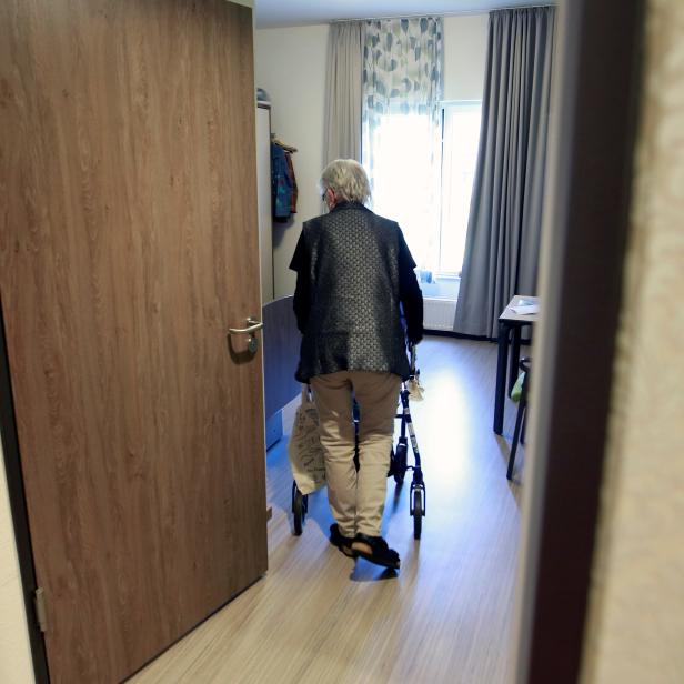 An elderly woman in a retirement home enters her apartment as visits have been restricted due to the coronavirus disease (COVID-19) concerns, in Grevenbroich