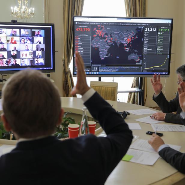 Members of the city commission to prevent the spread of coronavirus disease attend a meeting via video link in Lviv