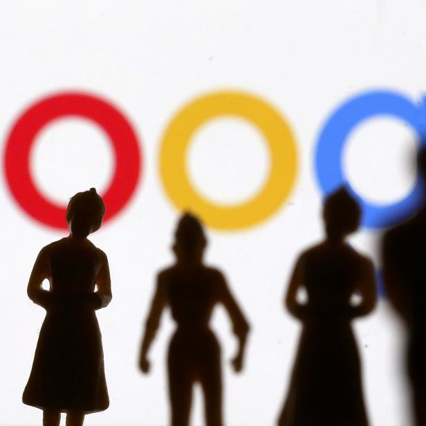 FILE PHOTO: Small toy figures are seen in front of Google logo in this illustration picture