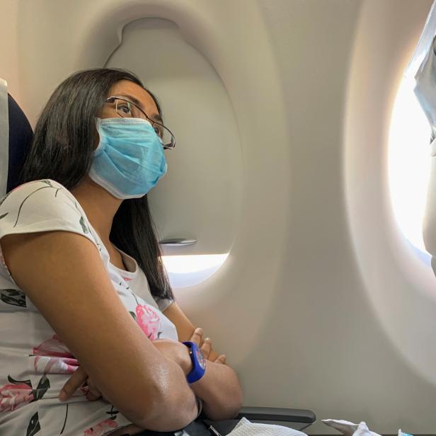 A passenger wears a protective mask on an Egyptair flight from Luxor to Cairo, following the outbreak of the coronavirus disease (COVID-19), in Egypt