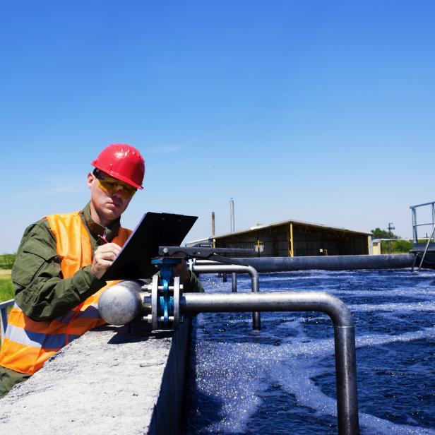 Worker inspecting valve