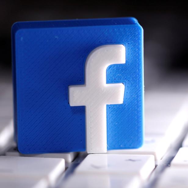 FILE PHOTO: A 3D-printed Facebook logo is seen placed on a keyboard in this illustration