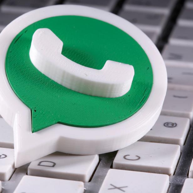 A 3D printed Whatsapp logo is placed on the keyboard in this illustration taken