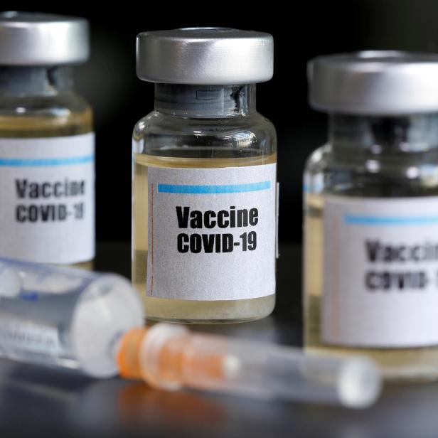 FILE PHOTO: Small bottles labbeled with a "Vaccine COVID-19" sticker and a medical syringe are seen in this illustration