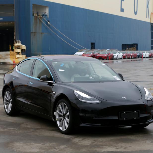 Tesla Model 3 car leaves a cargo vessel at a port in Shanghai