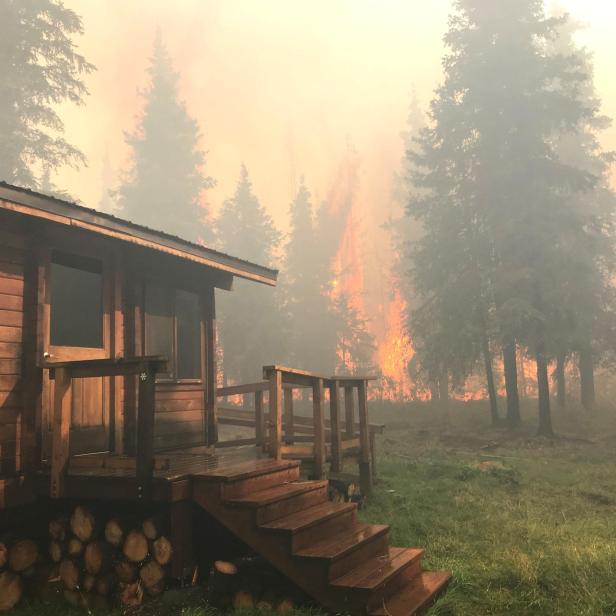 Firefighters from the Chugach National Forest work to protect the Romig Cabin on Juneau Lake from the Swan Lake Fire near Cooper Landing