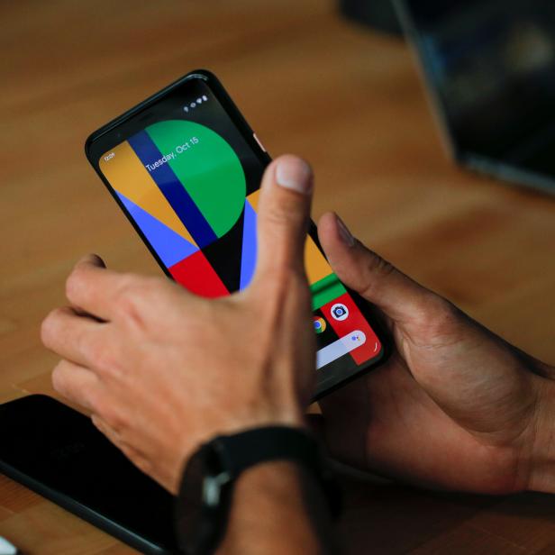 A woman takes a look on the new Google Pixel 4 smartphone displayed during a Google launch event in New York