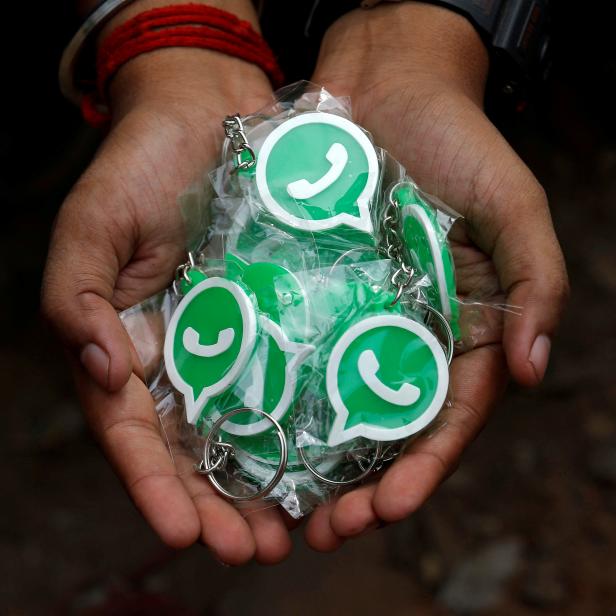 FILE PHOTO: A WhatsApp-Reliance Jio representative displays keychains with the logo of WhatsApp for distribution during a drive by the two companies to educate users, on the outskirts of Kolkata