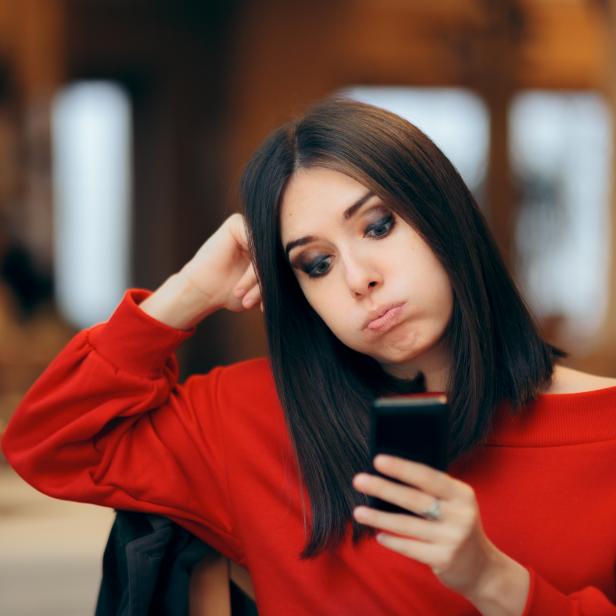Bored Woman Checking her Smartphone on a Date