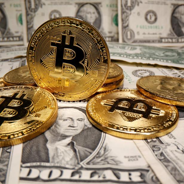 Representations of virtual currency Bitcoin are placed on U.S. Dollar banknotes