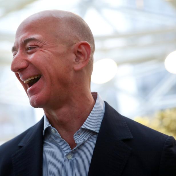 FILE PHOTO: Amazon founder and CEO Jeff Bezos laughs as he talks to the media while touring the new Amazon Spheres during the grand opening in Seattle