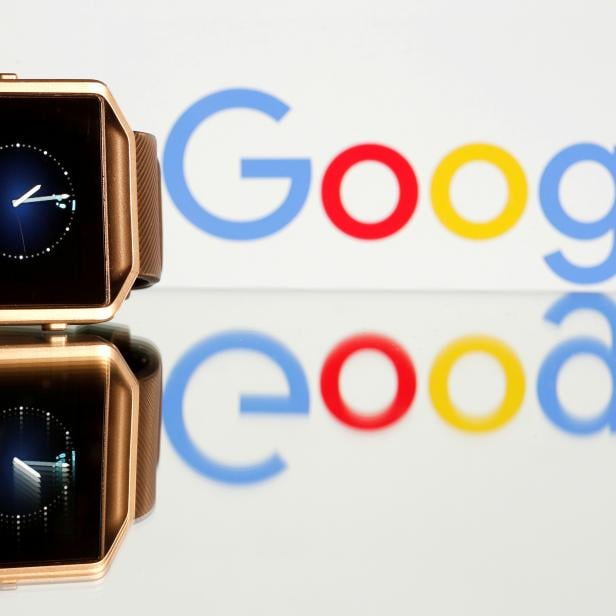 FILE PHOTO: FILE PHOTO: Fitbit Blaze watch is seen in front of a displayed Google logo in this illustration