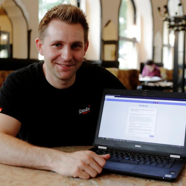 FILE PHOTO: Austrian lawyer and privacy activist Schrems displays his Facebook account's updated terms page during a Reuters interview in Vienna