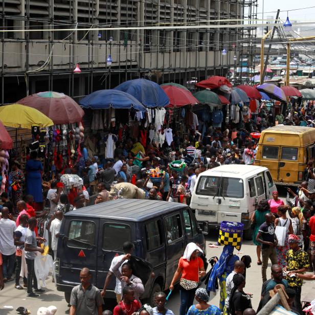 People shop at a market in Lagos