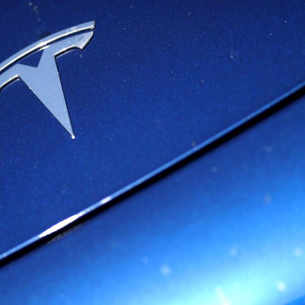 FILE PHOTO: The Tesla logo is seen on a car in Los Angeles