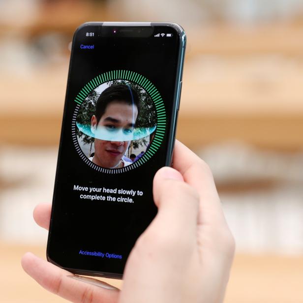 A customer sets up his iPhone X Face ID during its launch at the Apple store in Singapore