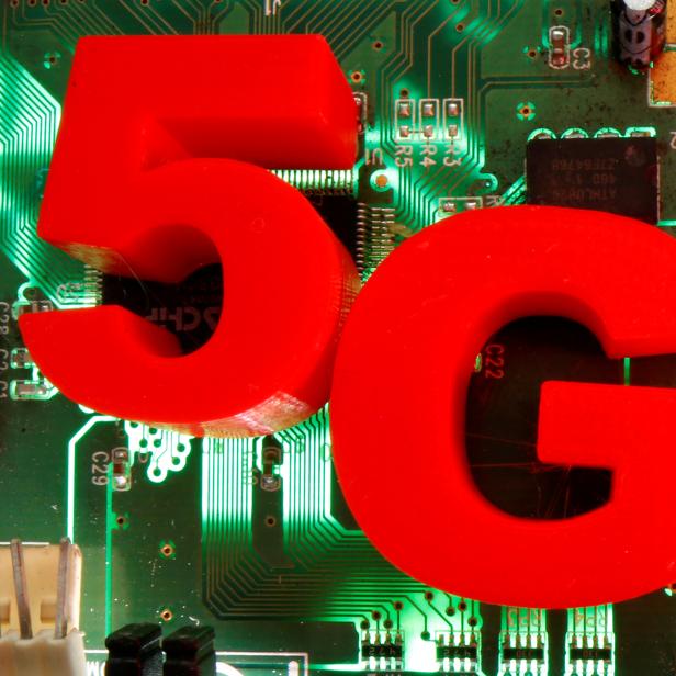 FILE PHOTO: 3D-printed objects representing 5G are put on a motherboard in this picture illustration