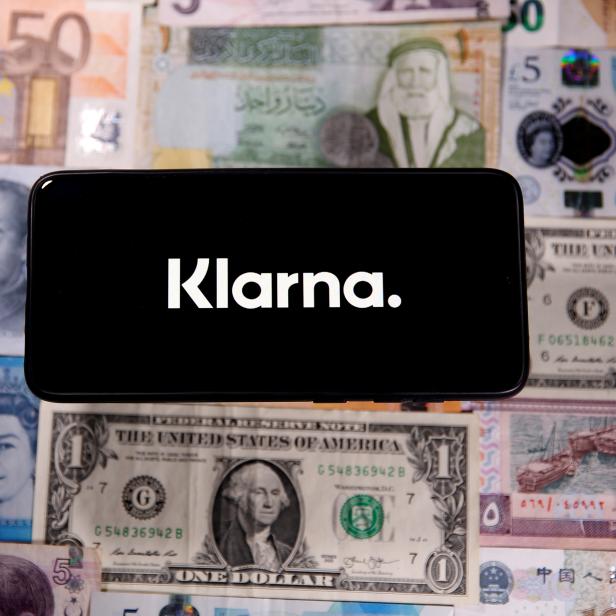 FILE PHOTO: A smartphone displays a Klarna logo on top of banknotes is in this illustration