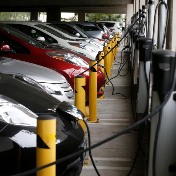 FILE PHOTO: Electric cars sit charging in a parking garage at the University of California, Irvine