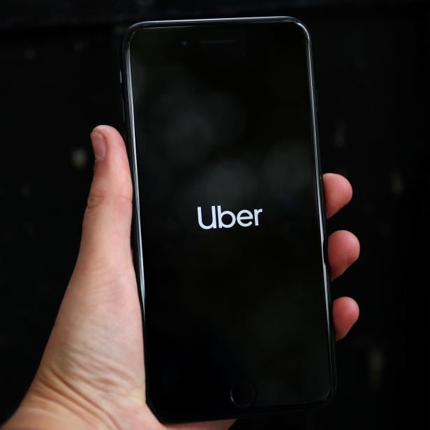 FILE PHOTO: Uber's logo is displayed on a mobile phone in London