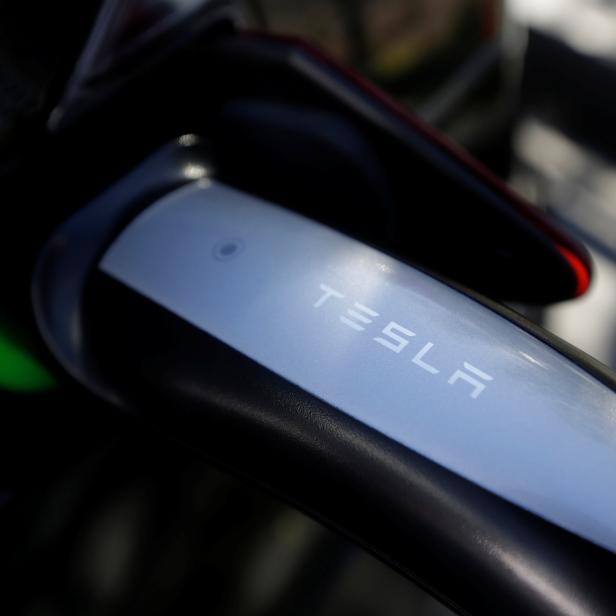 A Tesla Model S electric car is charged by a supercharger at a Tesla electric car dealership in Sydney