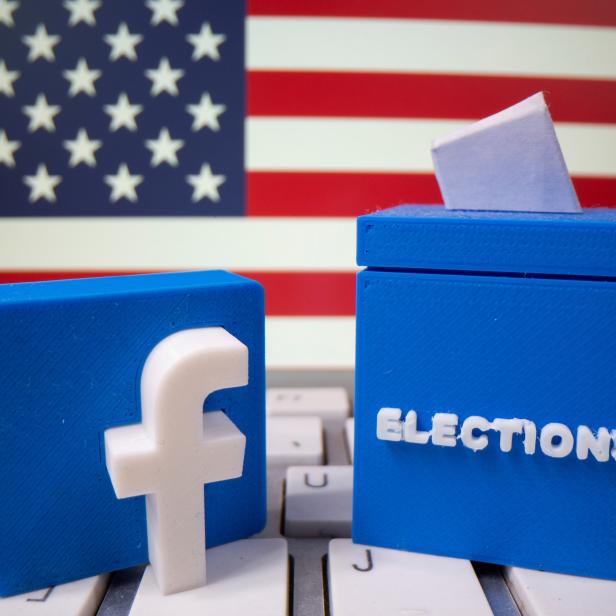 FILE PHOTO: A 3D-printed elections box and Facebook logo are placed on a keyboard in front of U.S. flag in this illustration