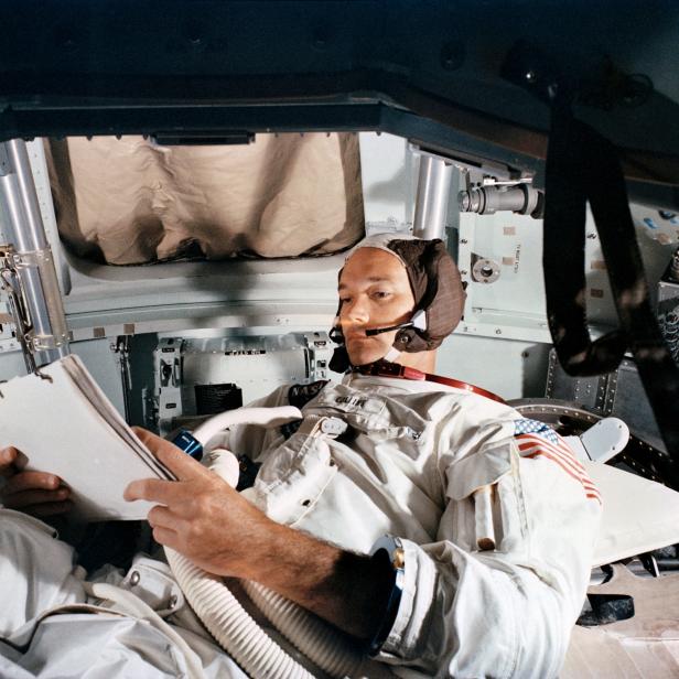 FILE PHOTO: Command Module pilot Michael Collins practices in the CM simulator at Kennedy Space Center