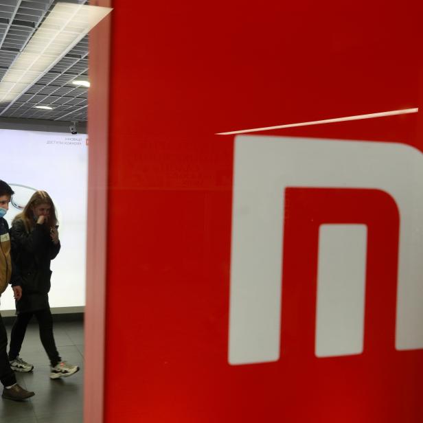 People wearing protective face masks visit Xiaomi brand's store in Kyiv