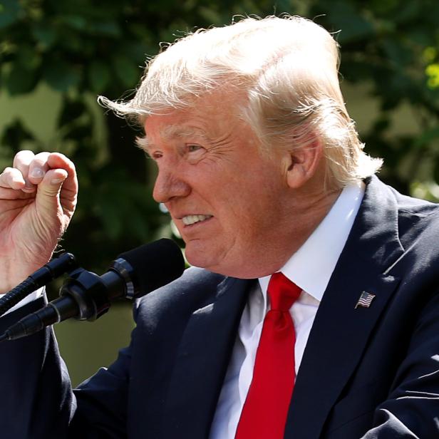 FILE PHOTO: U.S. President Trump refers to temperature change as he announces decision to withdraw from Paris Climate Agreement at White House in Washington