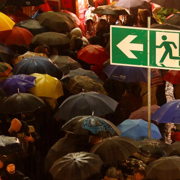 Visitors are seen under an emergency sign exit during the official opening of the traditional Christmas market in Frankfurt