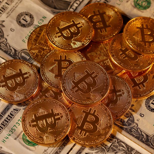 FILE PHOTO: Representations of virtual currency Bitcoin and U.S. dollar banknotes are seen in this picture illustration