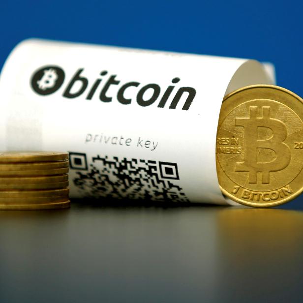 FILE PHOTO: An illustration photo shows a Bitcoin (virtual currency) paper wallet with QR codes and a coin are seen at La Maison du Bitcoin in Paris