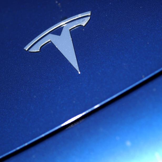 FILE PHOTO: The Tesla logo is seen on a car in Los Angeles