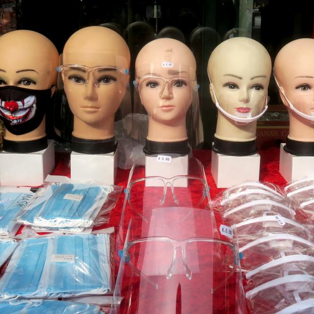 Protective face masks and face shields are on display at a market in Vienna