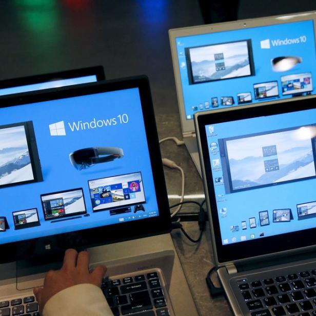 A reporter tries Windows 10 installed laptop computer at Microsoft China Center One during a media tour in Beijing 