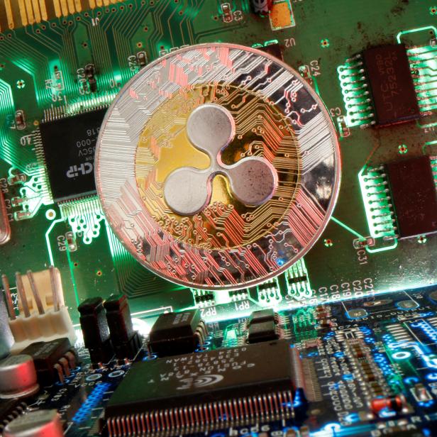 Representation of the virtual currency Ripple coin is seen on a motherboard in this picture illustration