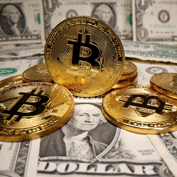 FILE PHOTO: Representations of virtual currency Bitcoin are placed on U.S. Dollar banknotes