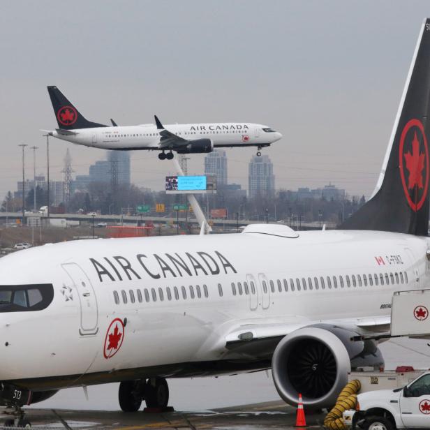 FILE PHOTO: An Air Canada Boeing 737 MAX 8 from San Francisco approaches for landing at Toronto Pearson International Airport over a parked Air Canada Boeing 737 MAX 8 aircraft in Toronto