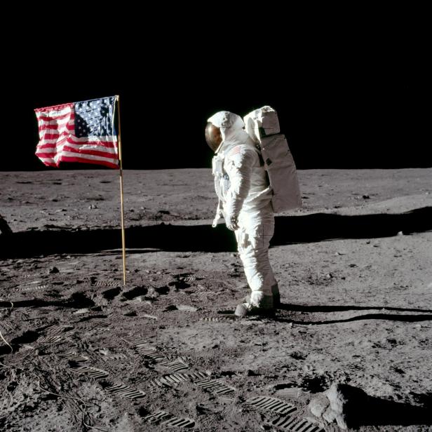 FILE PHOTO: Buzz Aldrin poses for a photograph beside the United States flag on the moon