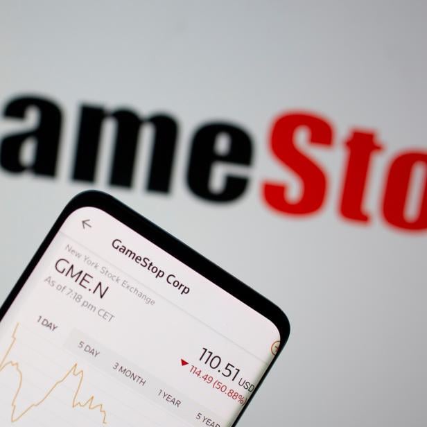 FILE PHOTO: GameStop stock graph is seen in front of the company's logo