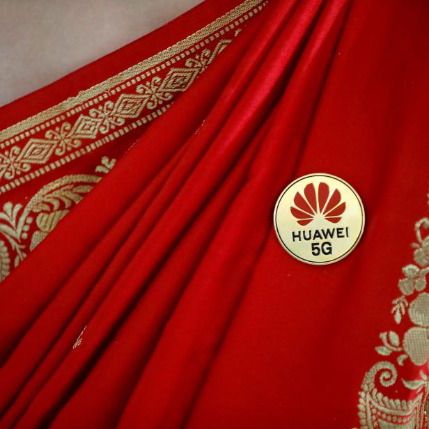 FILE PHOTO: Huawei's logo is seen on a badge pinned on a saree of a lady at the India Mobile Congress in New Delhi