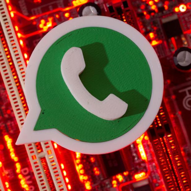 FILE PHOTO: A 3D printed Whatsapp logo is placed on a computer motherboard