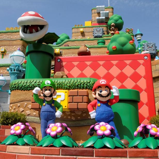 Mario and Luigi characters greet visitors inside Super Nintendo World at the Universal Studios Japan theme park in Osaka, Japan