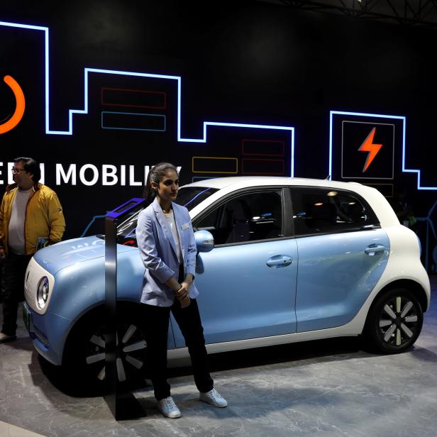 FILE PHOTO: Models pose next to Great Wall Motors (GWM) GWM R1 electric car at its pavilion at the India Auto Expo 2020 in Greater Noida