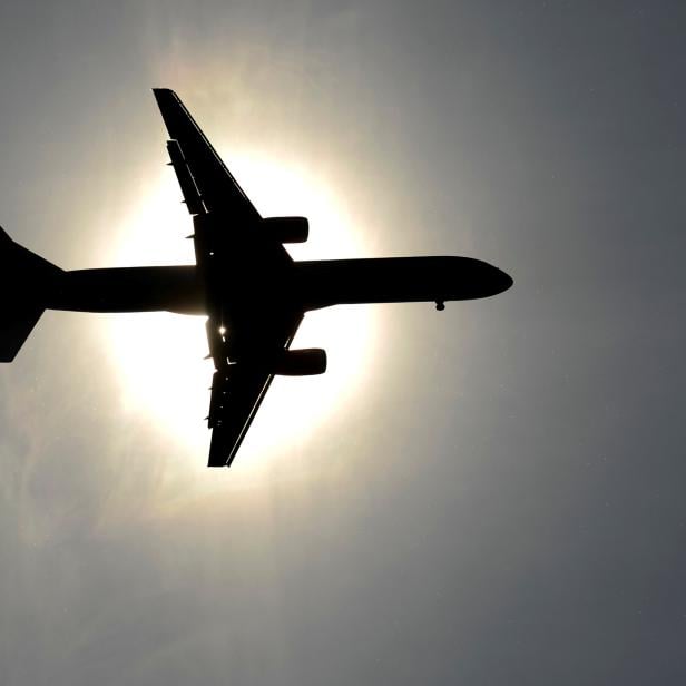 FILE PHOTO: Plane approaching Leeds Bradford airport passes in front of the sun in Leeds