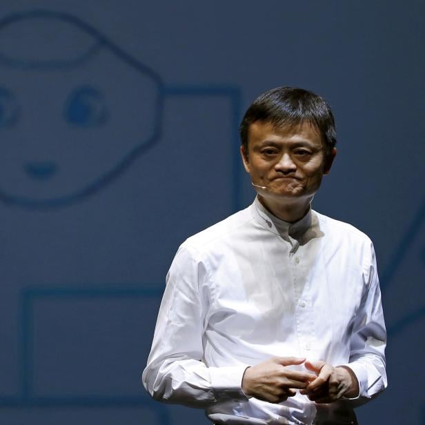 FILE PHOTO: Jack Ma, founder and executive chairman of China's Alibaba Group, speaks in front of a picture of SoftBank's human-like robot named 'pepper' during a news conference in Chiba
